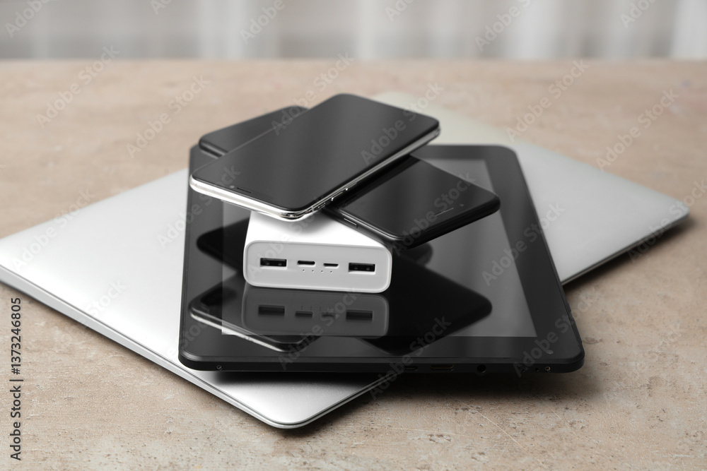 Stack of modern gadgets on grunge table