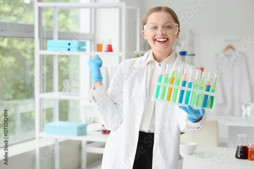 Happy female chemist with t...