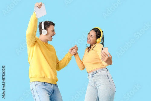 Young couple in headphones ...