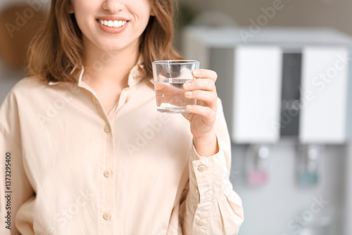 Smiling young woman drinkin...