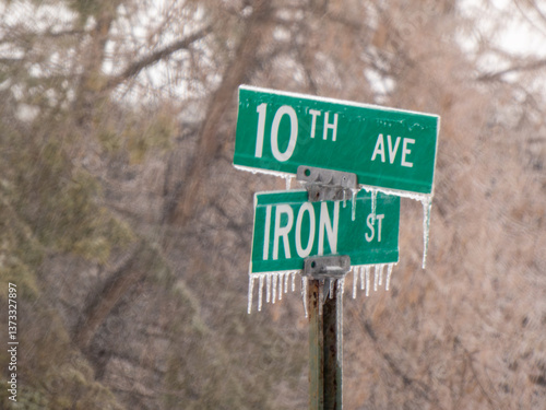 An ice-coated road sign in the freezing rain