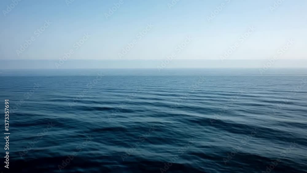 Serene Ocean Waters Calm Waves Under Clear Blue Sky, Evoking Tranquility and Peace, Perfect for Relaxation and Contemplation on Horizon.