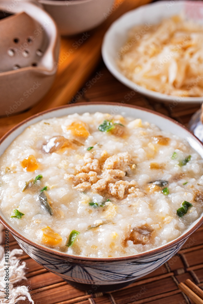 Minced pork congee with preserved egg on the table Minced pork congee with preserved egg on the table