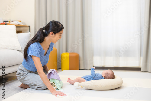 Obraz na płótnie Young mother doing housework with baby w salonie