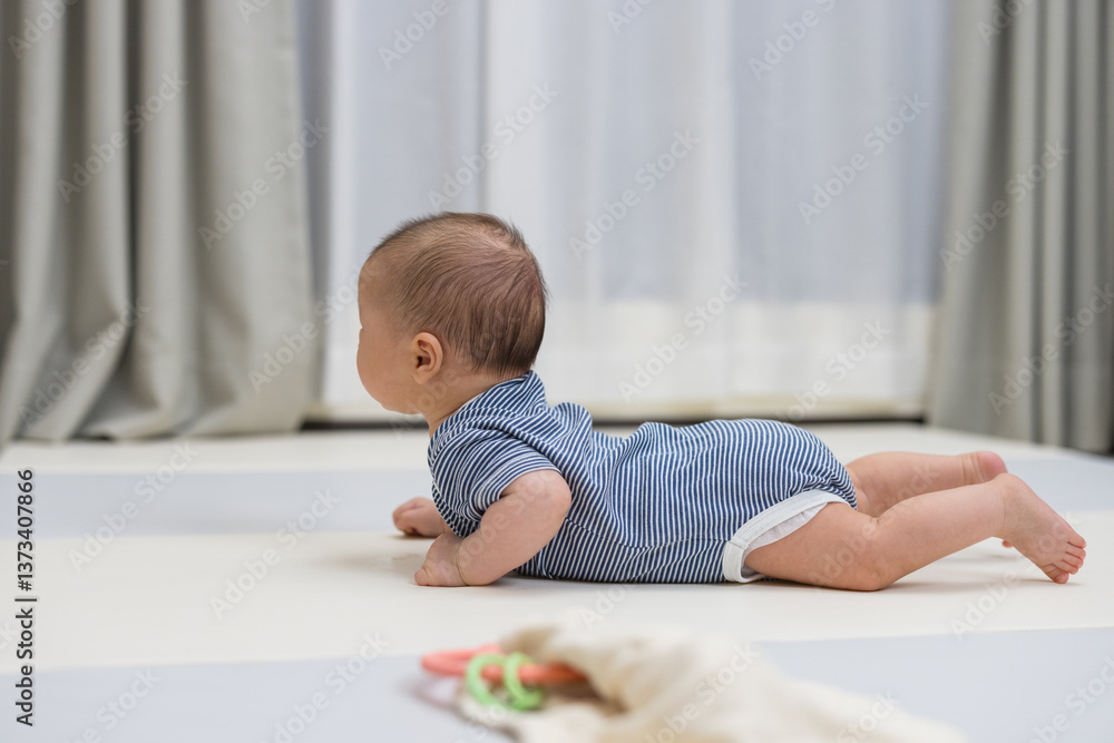 Little newborn baby on soft crawling mat