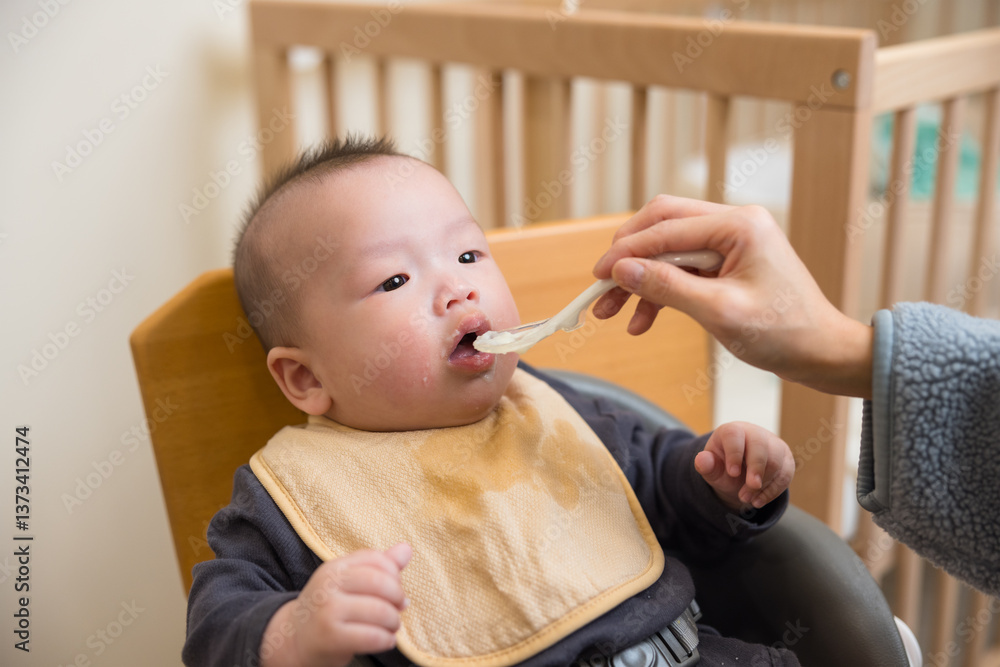 Little Baby Trying First Solid Food With Mom