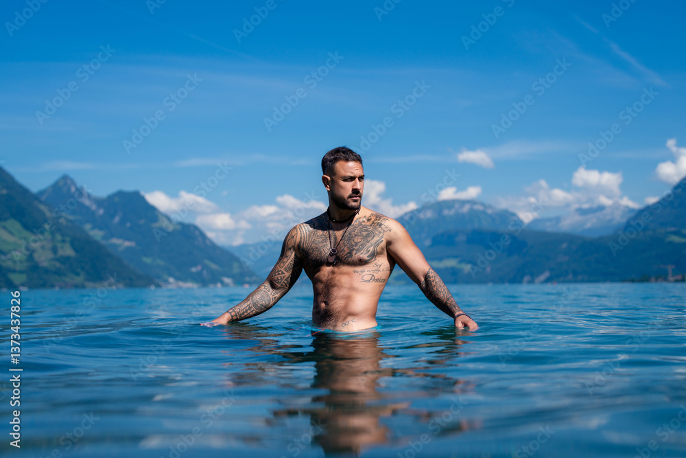 Fototapeta premium Sexy summer man. Wet muscular male body in water. Nude sexy male body. Man splash in water in summer nature. Fit man posing by summer beach. Strong man splashing in a mountain lake. Summer trip.
