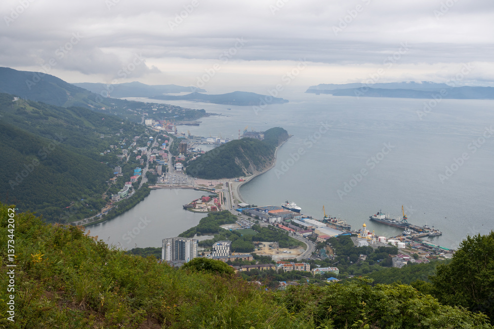 View from Mishennaya Sopka to the port city of Petropavlovsk-Kamchatsky, located on the coast of the Avacha Bay of the Pacific Ocean. Kamchatka, Far East of Russia. Top view of buildings and streets.