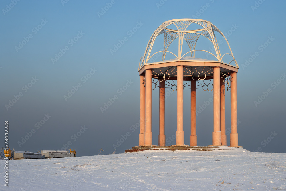 Gazebo on top of Mount Samokhval (also known as Mount Love) near the city of Abakan. Republic of Khakassia, Siberia, Russia. Winter landscape. Cold frosty weather. Empty metal gazebo among snow.