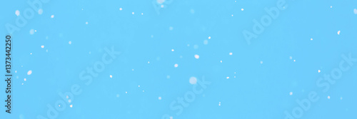 Obraz na płótnie Wide panoramic winter background. Texture with snowfall. Winter. Flying small and large snow flakes on a light blue background. w salonie