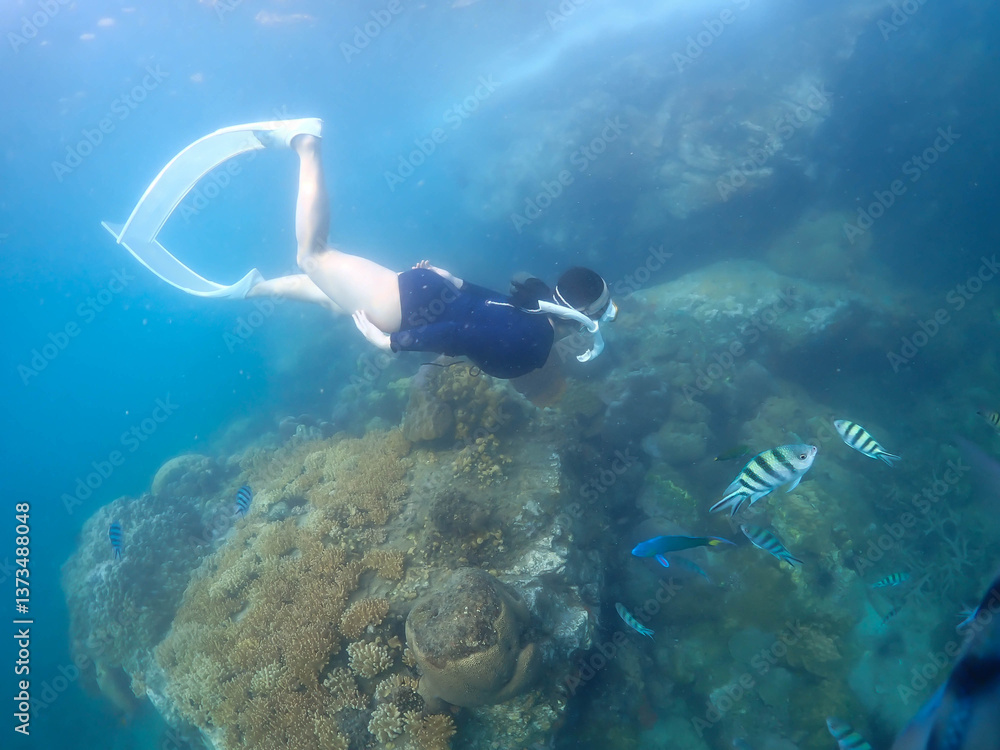Fototapeta premium Beautiful snorkeling in the tropical sea.Travel lifestyle, watersport adventure, swim activity on summer beach holiday
