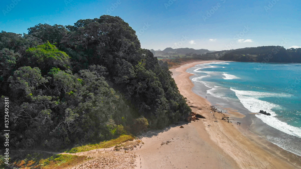 Aerial shot of Hot Water Beach’s golden sands and geothermal pools in New Zealand