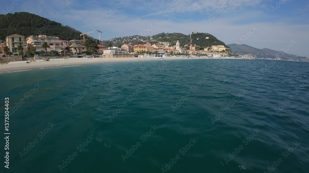 fast FPV aerial journey from the sea into Noli, Italy in the Province of Savona then up the scenic beach coastline on the Ligurian Sea fast FPV aerial journey from the sea into Noli, Italy in the Province of Savona then up the scenic beach coastline on the Ligurian Sea