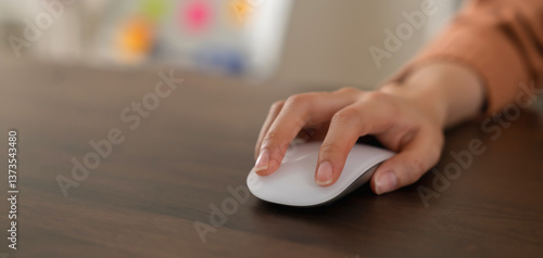 Close up of hand press the button computer mouse on table.