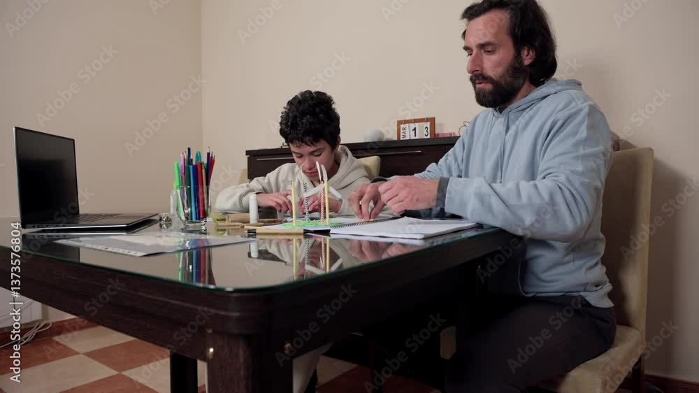 Father Assisting Teenager Learning at Home During Bonding Session Father Assisting Teenager Learning at Home During Bonding Session