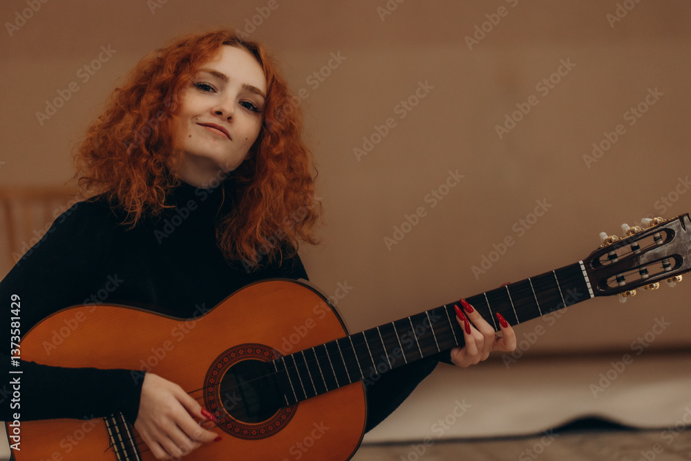 Fototapeta premium Young Woman with Red Hair Playing Acoustic Guitar Indoors