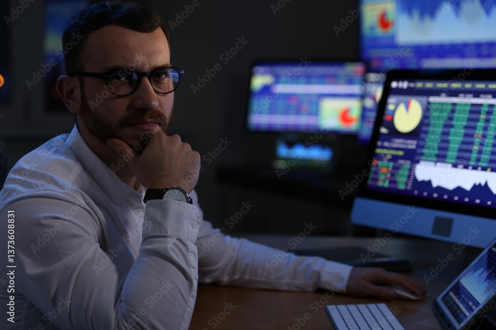 Portrait of financial trading specialist in office at night Portrait of financial trading specialist in office at night