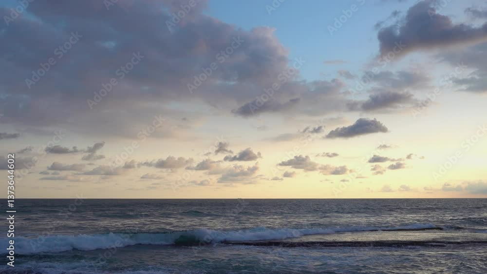 Serenity of the ocean captured at sunset with gentle waves and a cloudy sky. Soft pastel colors blend seamlessly, creating a calming seascape scene with a tranquil atmosphere. Serenity of the ocean captured at sunset with gentle waves and a cloudy sky. Soft pastel colors blend seamlessly, creating a calming seascape scene with a tranquil atmosphere.