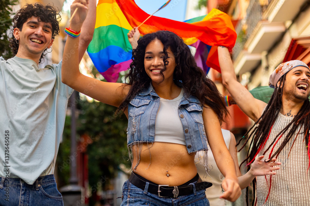 Obraz premium Happy multiethnic friends waving rainbow flag at lgbtq pride parade celebrating gay rights