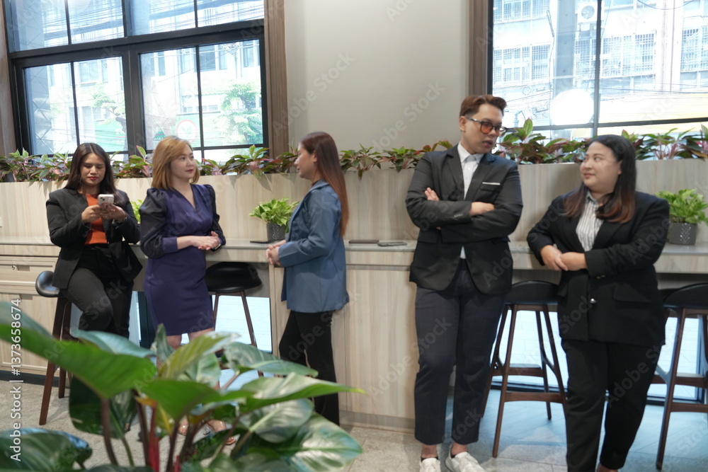 Group of Asian female employees sitting in meeting discussing marketing and sales work, planning together in living room in company office lobby.