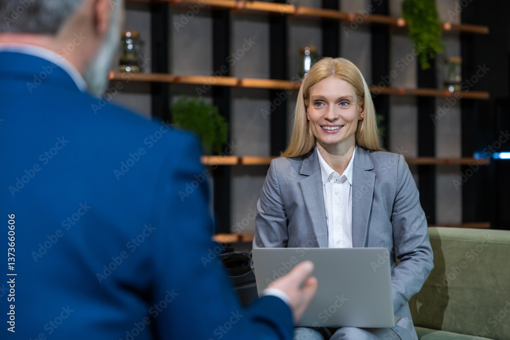 Fototapeta premium Blonde business woman having an interview with a work candidate and looking involved