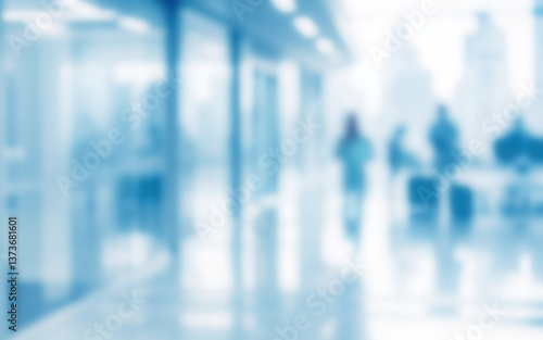 Defocused blurry photo of light modern office with group of people. Abstract business background.
