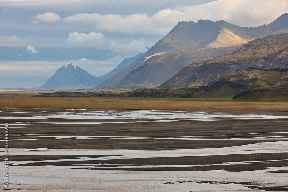 Water and sand from glaciers landscape. Lonsvik. East fjords. Iceland