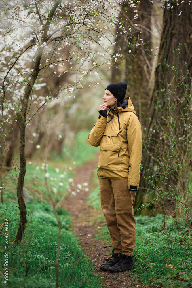 Obraz premium A girl walking through nature and enjoying the beautiful and blooming spring.