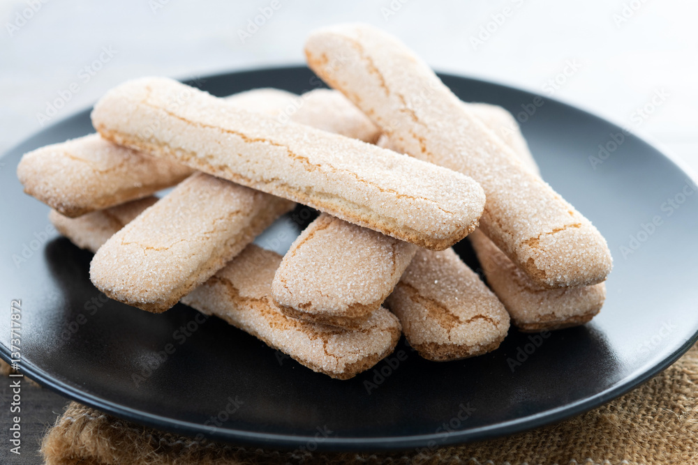 Italian biscuits ladyfingers savoiardi on wooden table Italian biscuits ladyfingers savoiardi on wooden table