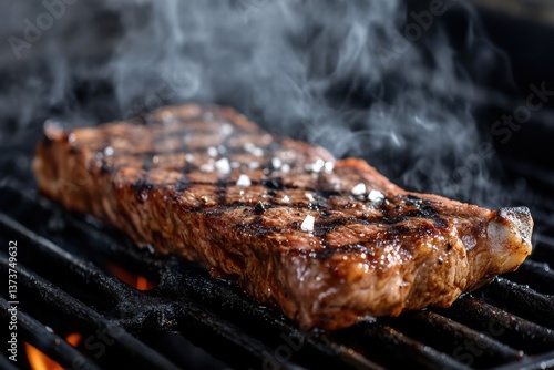 Grilled steak with charred marks and sizzling smoke
