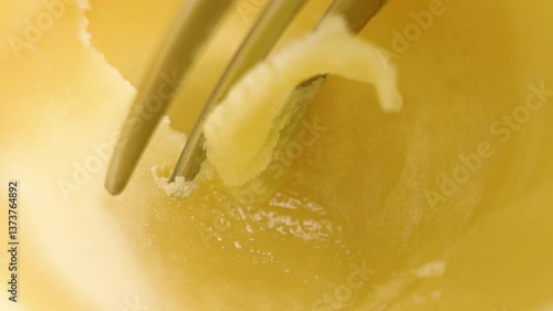 A fork scrapes fresh ghee clarified butter. Healthy homemade fatty ingredient. Macro shot