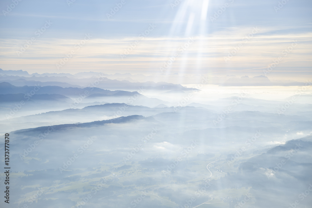 Obraz premium Wide aerial view over the Adelegg, Schwarzer Grat, Nagelfluh heights, Hauchenberg ridge, and the surrounding Allgäu region between Isny and Niedersonthofen during a temperature inversion. 