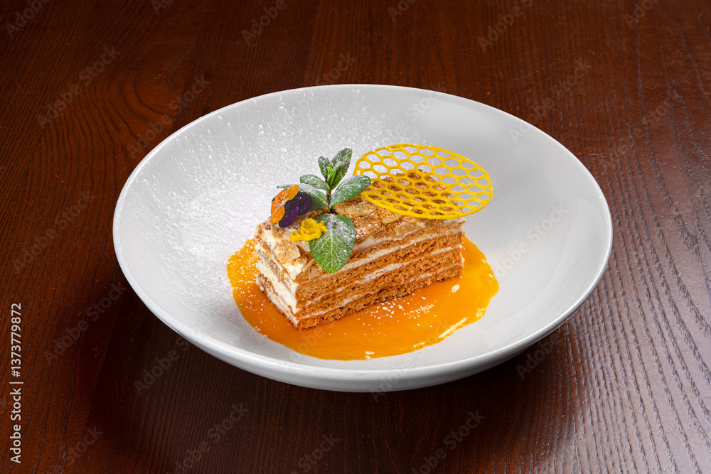 Honey cake with buttercream and honeycomb and flower decoration in a white plate Honey cake with buttercream and honeycomb and flower decoration in a white plate