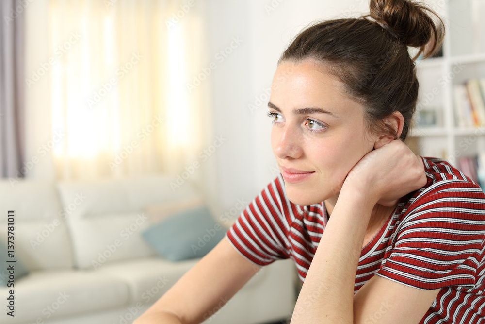 Pensive woman at home looking away Pensive woman at home looking away