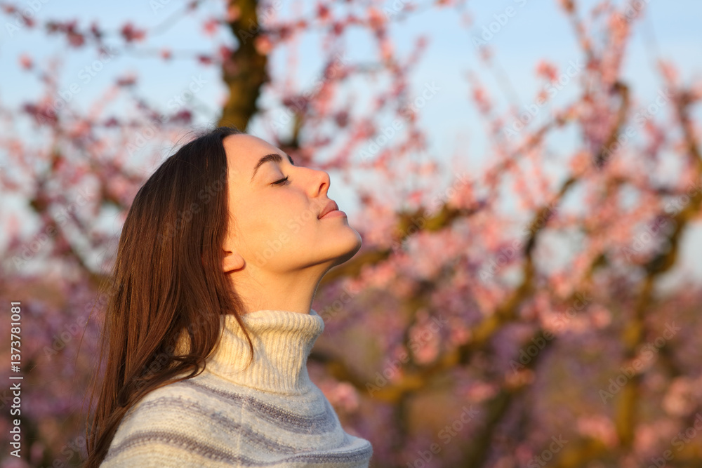 Fototapeta premium Woman at sunset in winter breathing fresh air