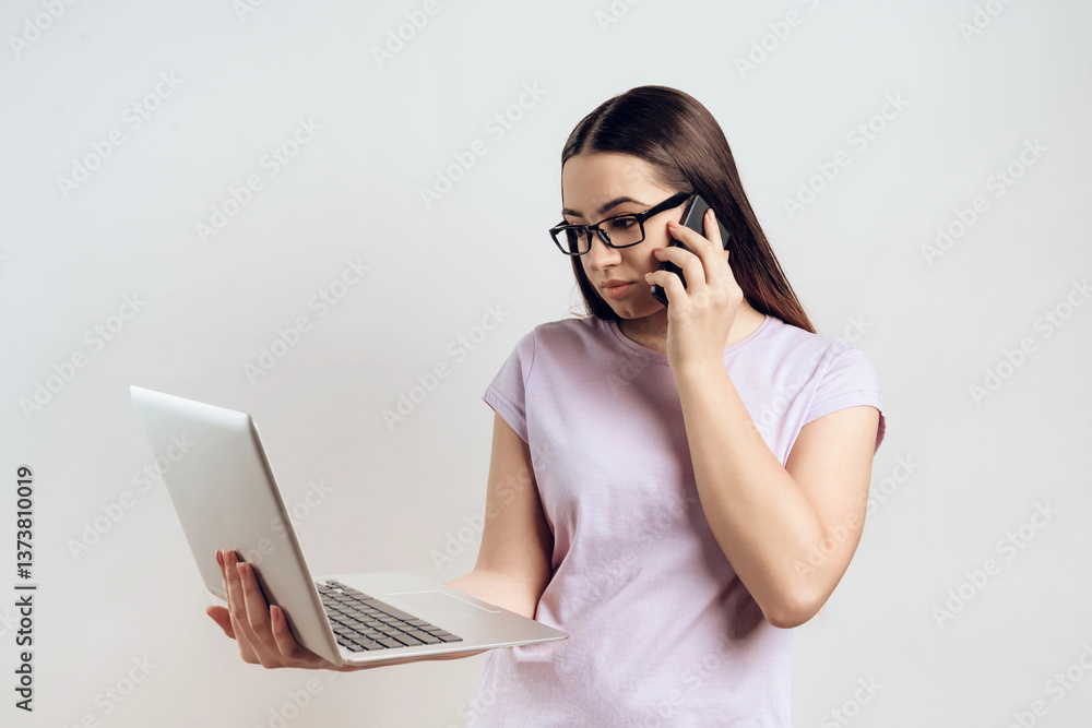 Young girl is typing on laptop while talking Young girl is typing on laptop while talking