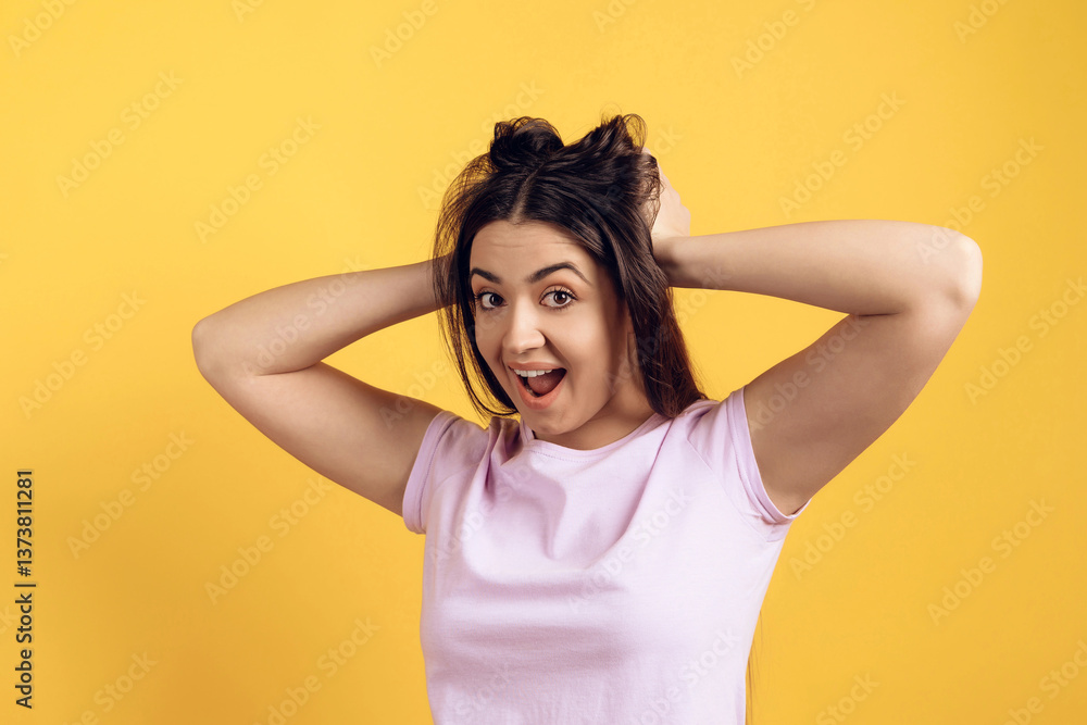 Fototapeta premium Young joyous girl ruffles long hair on head.