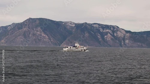 A pleasure boat goes on Lake Baikal. Side view. summer, sunny day. Vacation, recreation, tourist destination, water recreation. High quality FullHD footage