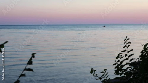 Beautiful, summer, warm sunset on the shores of the Black Sea. Vacation, recreation, tourism. A tourist boat floats in the distance. High quality FullHD footage