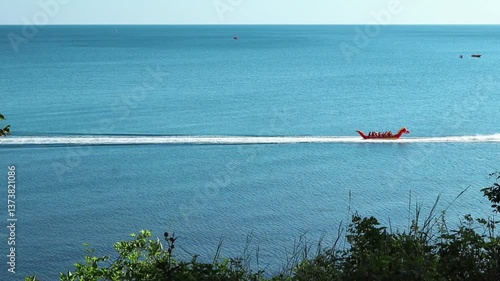 A motor boat carries happy people on an inflatable banana along the Black Sea. Krasnodar region. Vacation, relaxation, entertainment. High quality FullHD footage