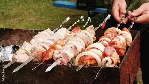 Male hands fry shish kebab on the grill. Healthy food, outdoor food, campfire food. High quality FullHD footage
