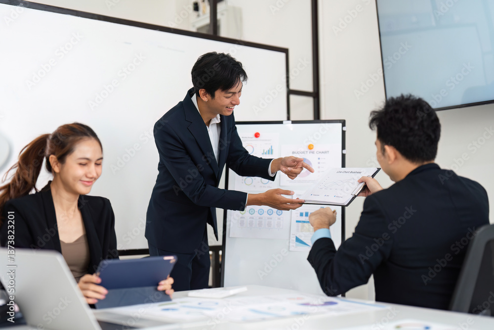 Creative Collaboration and Data Presentation. A young professional sharing analysis of budget details with colleagues during an interactive meeting. Creative Collaboration and Data Presentation. A young professional sharing analysis of budget details with colleagues during an interactive meeting.
