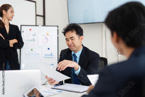 Wallpaper Mural Effective Leadership and Team Collaboration. A manager guiding team discussions in a strategic meeting. Torontodigital.ca