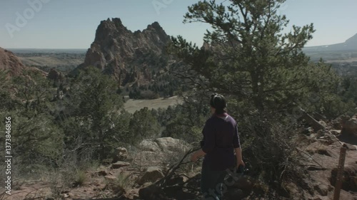 Lady Hiking and taking a photo of the Garden of the gods