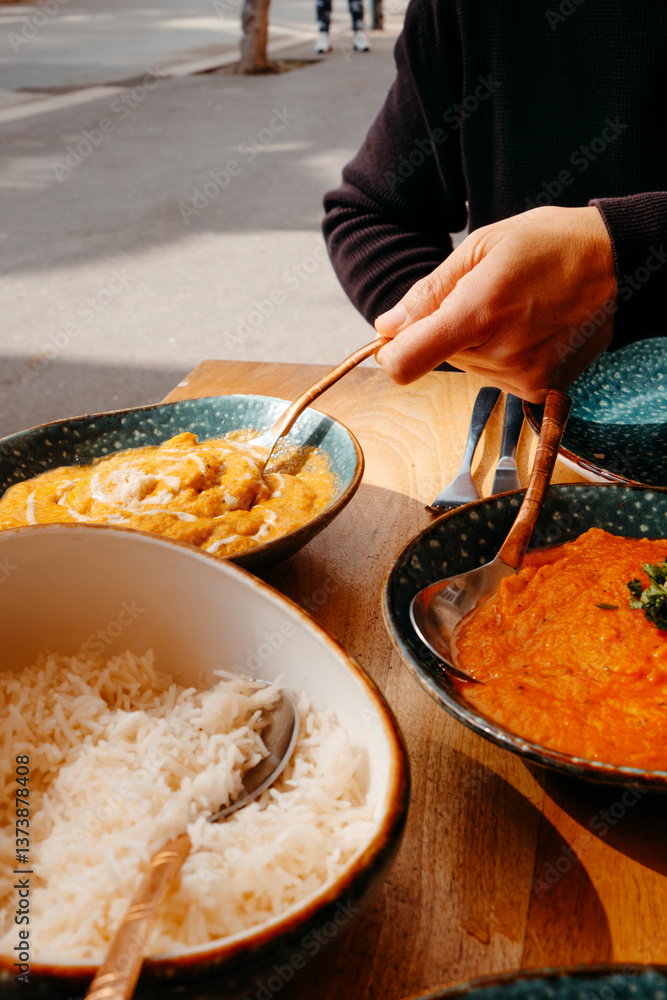 man about to serve some chicken korma