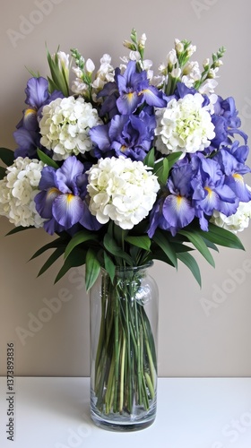 Wallpaper Mural Colorful arrangement features blue irises and white hydrangeas in clear glass vase, beautifully illuminated by natural light Torontodigital.ca