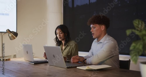 Wallpaper Mural Collaborating on laptops, diverse colleagues in office during evening meeting session Torontodigital.ca