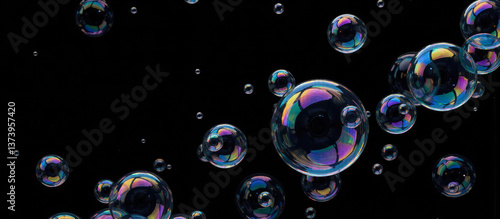 Bright soap bubbles of different sizes reflecting light in dark space, perfect for creative backgrounds and visual effect