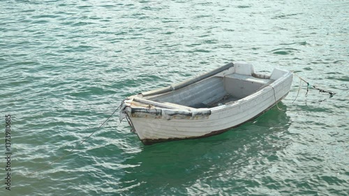 Wallpaper Mural Small, weathered boat drifts gently on calm waters, surrounded by tranquil coastal environment. Peaceful setting highlights the beauty of nature and solitude by the shore. Torontodigital.ca