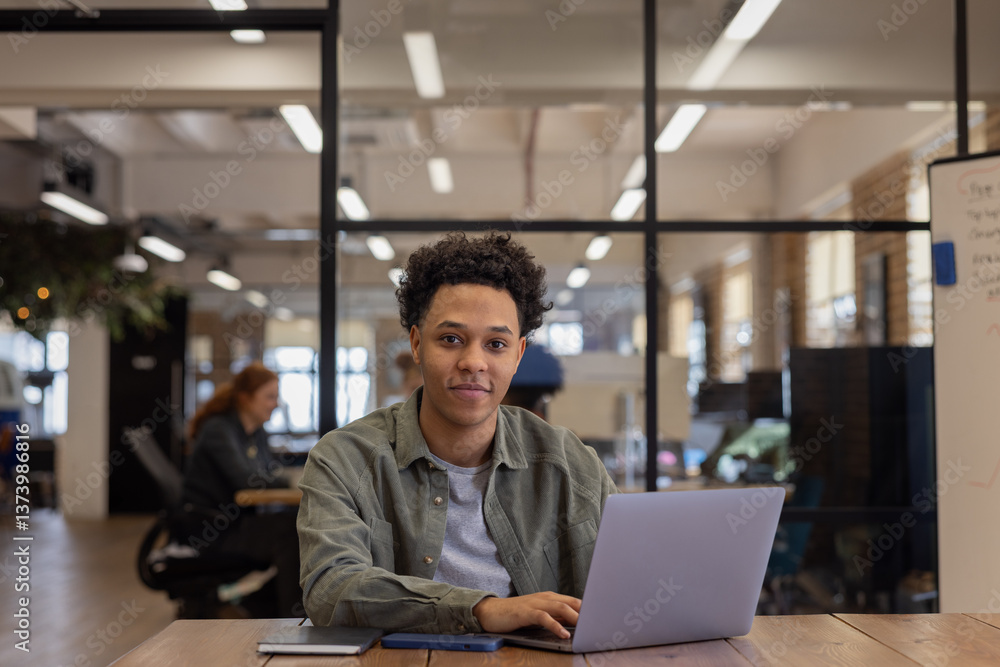 Portrait of a young employee with Laptop in an Office Portrait of a young employee with Laptop in an Office